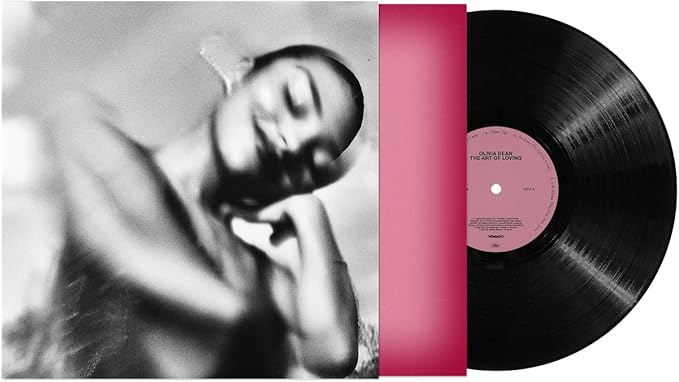 Vinyl record with a pink label and a black and white photo of a person on the cover.