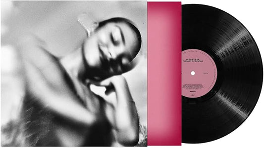Vinyl record with a pink label and a black and white photo of a person on the cover.