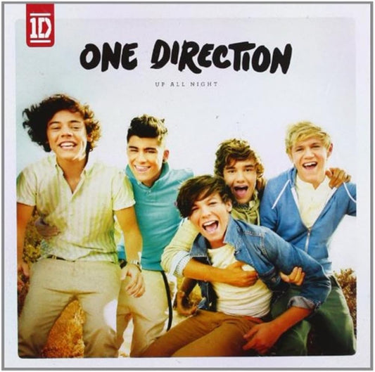Album cover of One Direction with four members posing outdoors, featuring the band's logo.