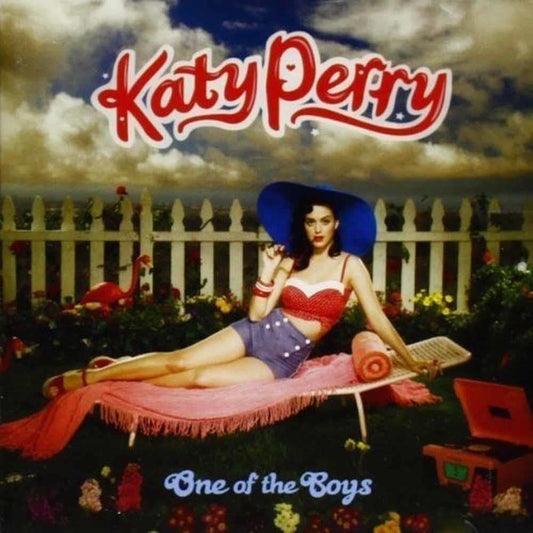 Album cover featuring a person in a patriotic outfit lying on a blanket with 'Katy Perry' and 'One of the Boys' text.