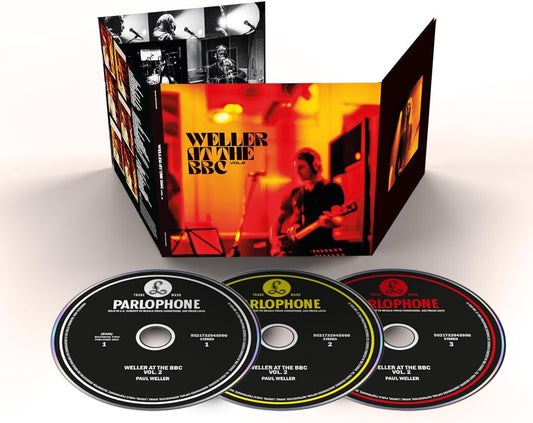 Music album packaging with three CDs and a box set featuring a musician on stage.