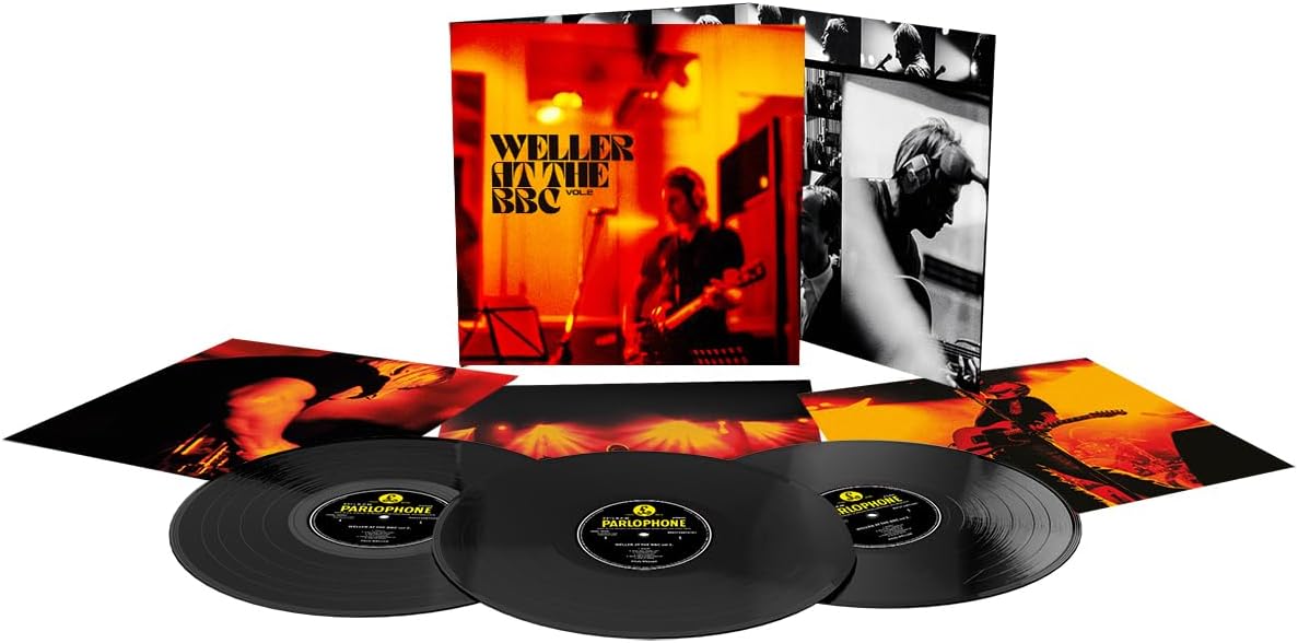 Vinyl record set with cover and three records on a white background