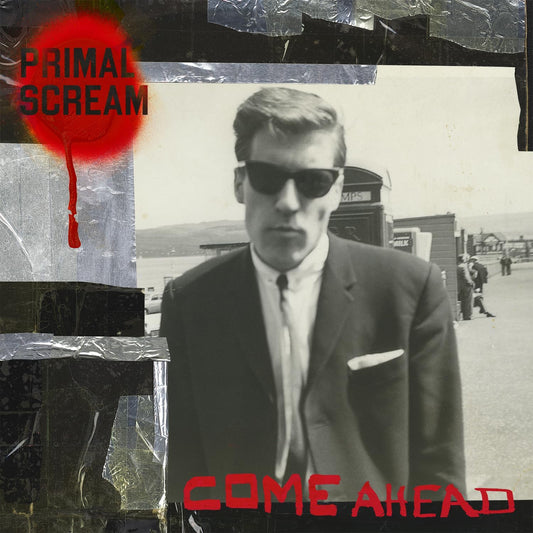 The image shows the cover of the Primal Scream album 'Come Ahead' on black vinyl. It features a black and white photo of a man with sunglasses and a suit, with the band name and album title text in red and white.