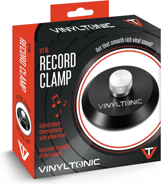 Packaging of the Vinyl Tonic Record Clamp, featuring the black clamp itself on the front with the product name and branding, set against a black and orange background.
