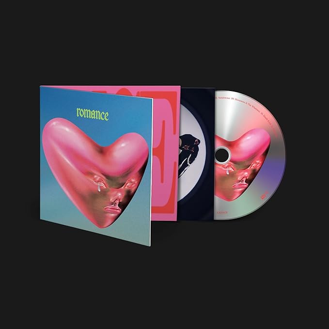 CD case and disc for the album 'Romance' by Fontaines D.c., featuring a pink and blue heart-shaped design on the cover.