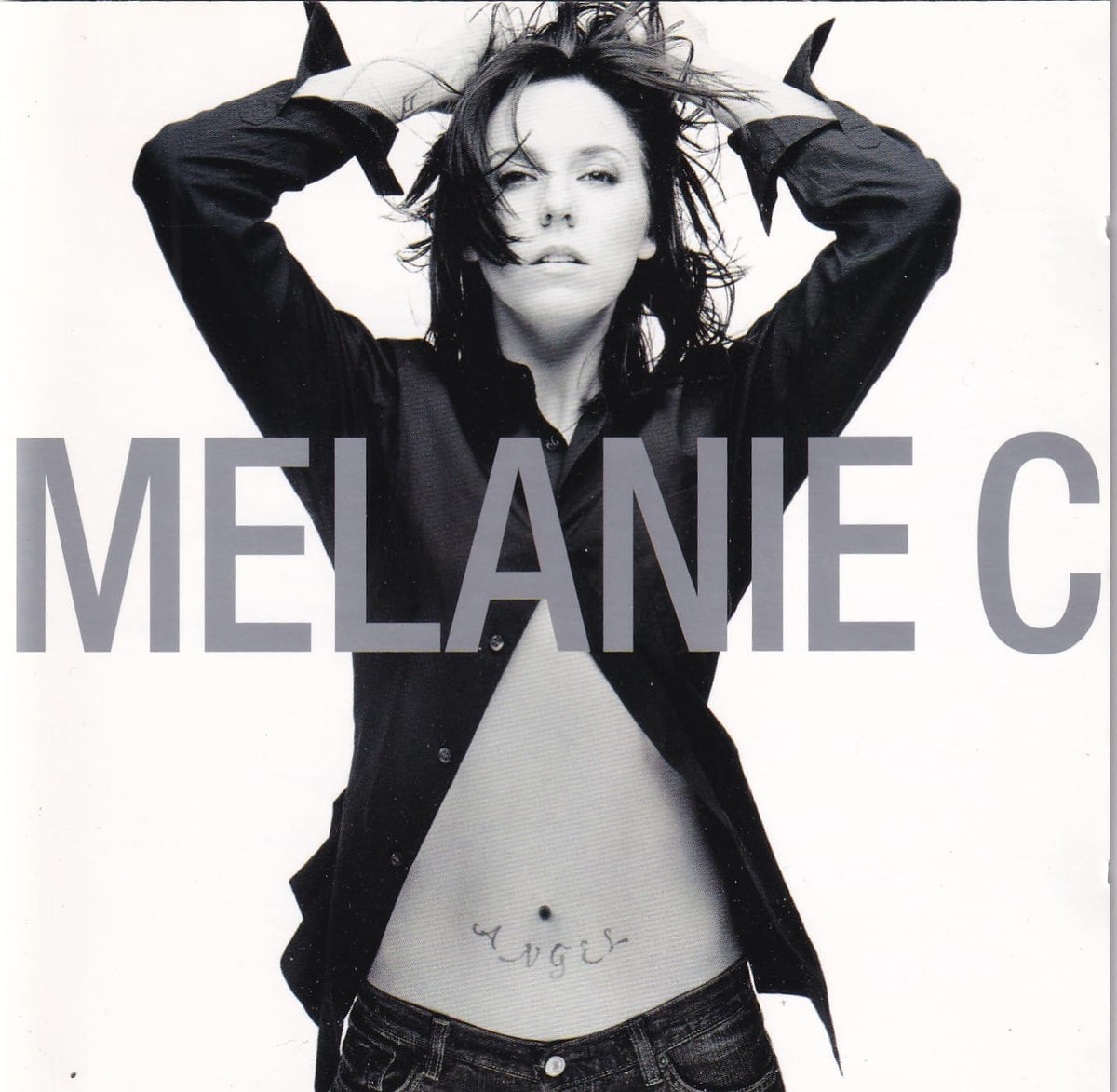 Person with arms raised wearing a black shirt and jeans, with 'Melanie C' text overlay.