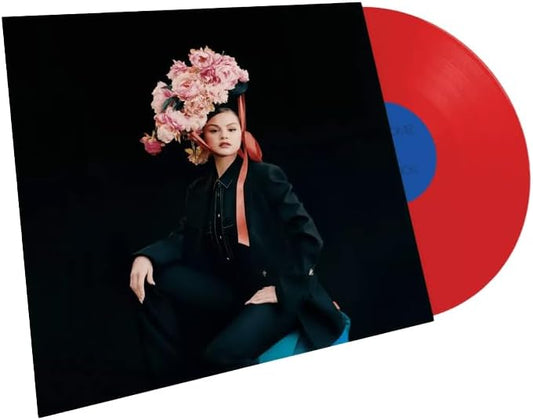 Vinyl record with a cover featuring a person with flowers in their hair on a black background.