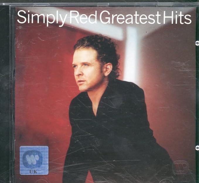 Audio CD cover of Simply Red Greatest Hits, featuring a man with red hair and a red background, with the band's name and album title prominently displayed.