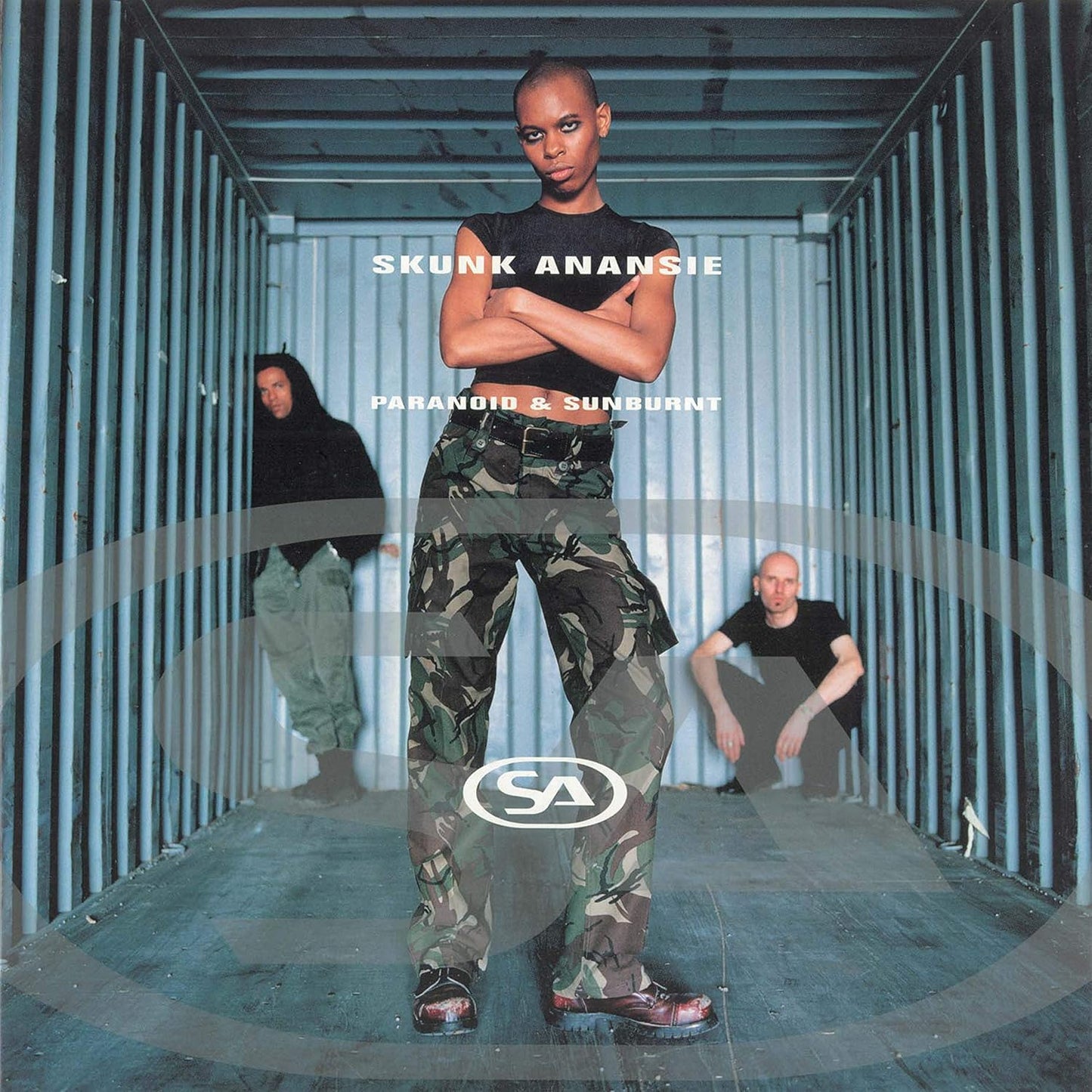 Album cover for Skunk Anansie's 'Paranoid & Sunburnt' with a person in camouflage pants standing in a container.