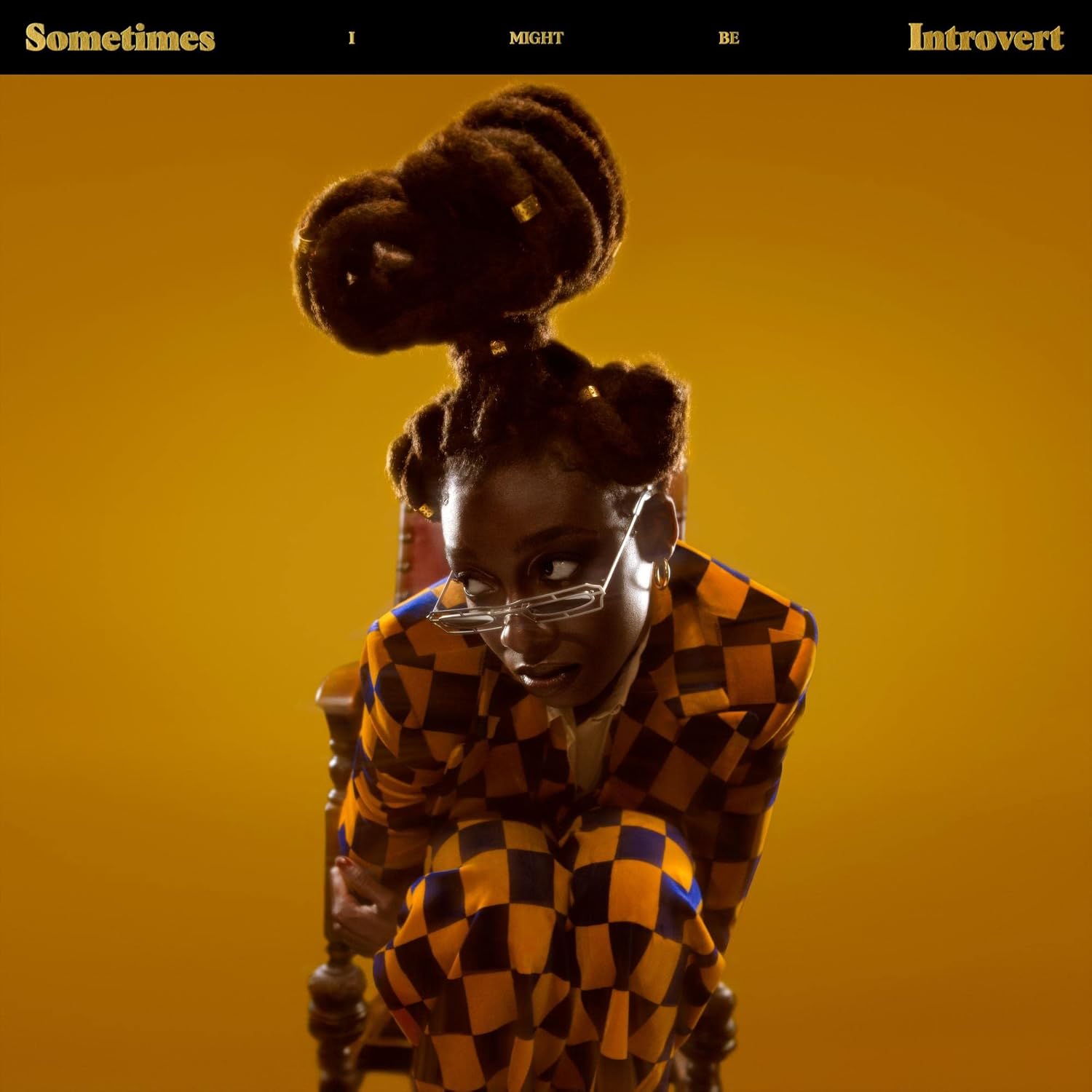 Person wearing a checkered outfit with a yellow background and text about introversion.