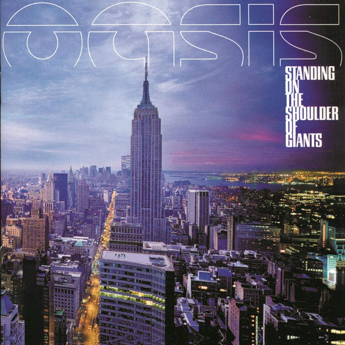Album cover for Oasis' 'Standing on the Shoulder of Giants' featuring a city skyline with the Empire State Building at dusk, large outlined 'OASIS' text across the top, and the album title on the right.