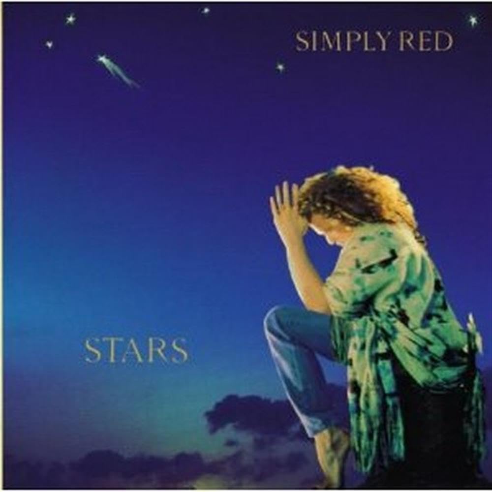 Album cover for Simply Red's 'Stars', featuring a woman in a green tie-dye shirt and blue jeans sitting in profile against a deep blue night sky with stars.