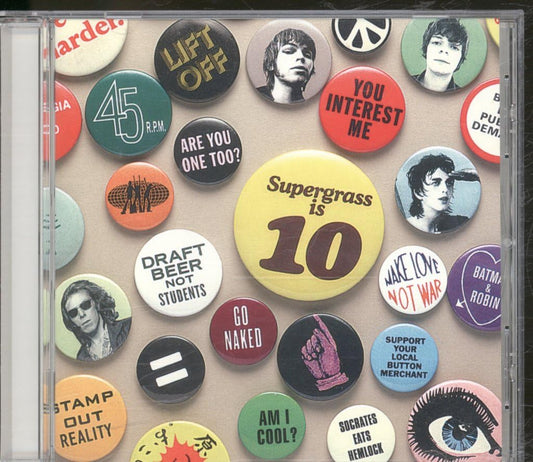 CD cover with button-style artwork featuring various phrases and images, including 'Supergrass is 10'.