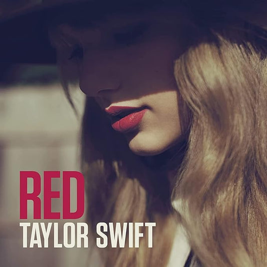 A CD cover featuring the artist name 'Taylor Swift' and the album title 'Red' with a red and white color scheme.