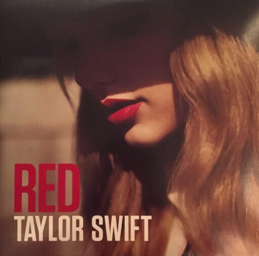Vinyl record cover featuring Taylor Swift with a red background and the title 'RED' prominently displayed.