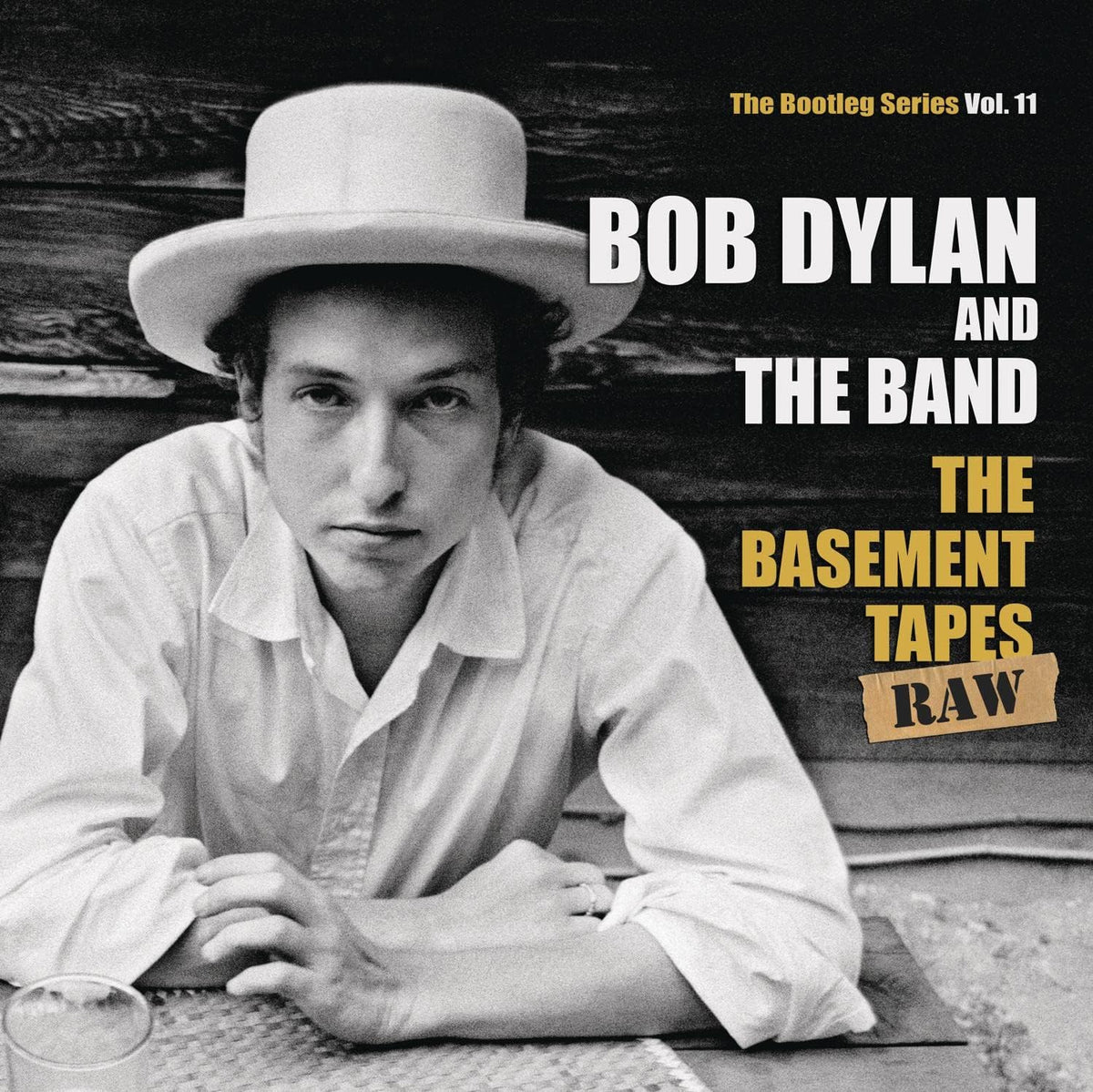 Album cover featuring Bob Dylan and The Band with text about 'The Basement Tapes Raw'.