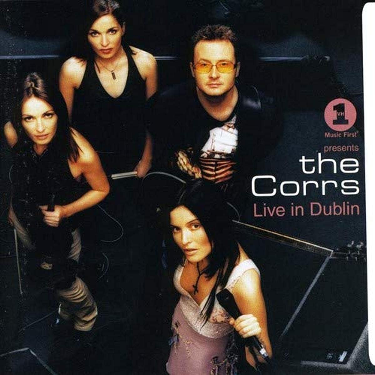 Promotional poster for The Corrs live in Dublin featuring four band members.