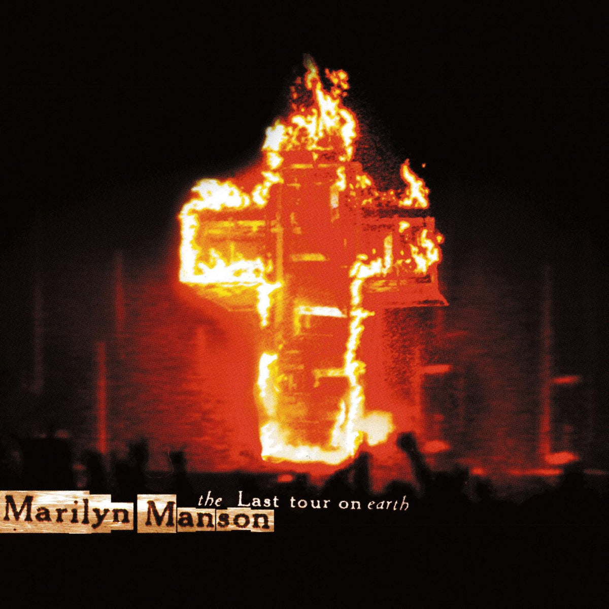 Flaming cross with 'Marilyn Manson' text on a dark background