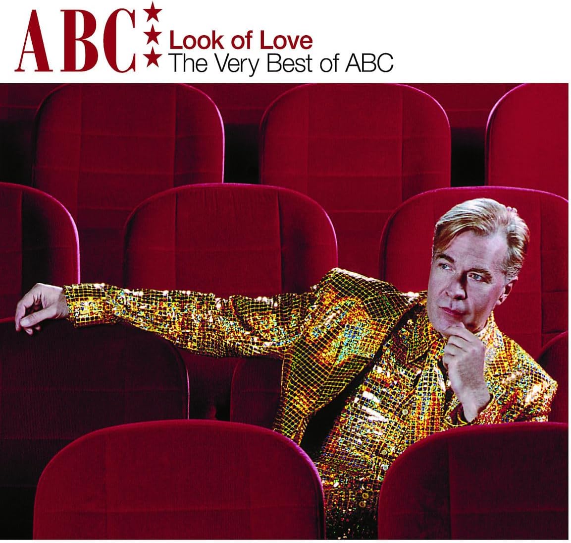 Album cover for 'Look of Love: The Very Best of ABC' featuring a man in a gold sequined jacket sitting in red theater seats, with the title text at the top.