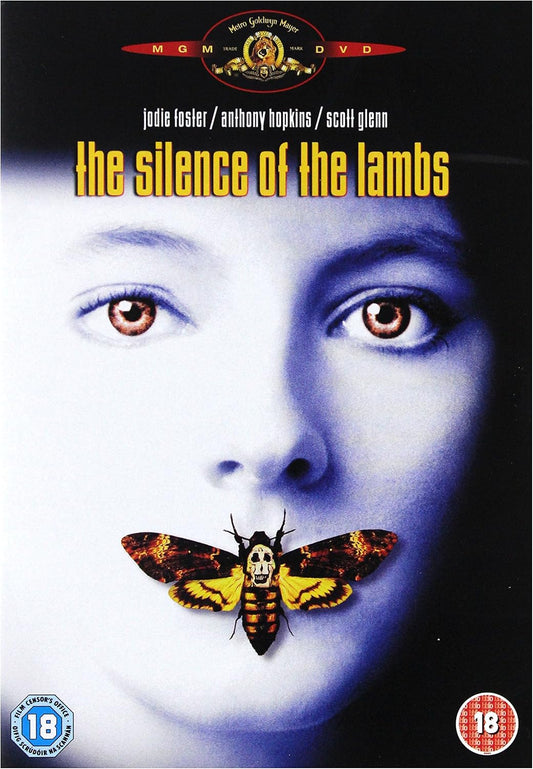 DVD cover for the movie 'The Silence of the Lambs' featuring a close-up of a woman's face in cool blue tones with a large moth over her mouth. The MGM logo appears at the top, and age rating badges are visible in the corners.