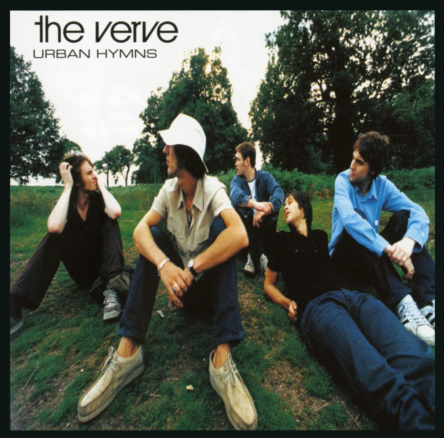 Album cover of 'Urban Hymns' by The Verve featuring five band members sitting on grass.