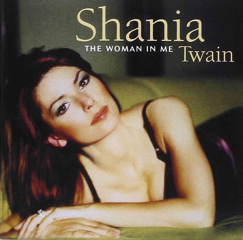 Album cover featuring a woman with text 'Shania Twain The Woman in Me'