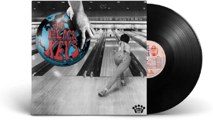 Vinyl record with a cover featuring a bowling alley scene and 'The Black Keys' branding.