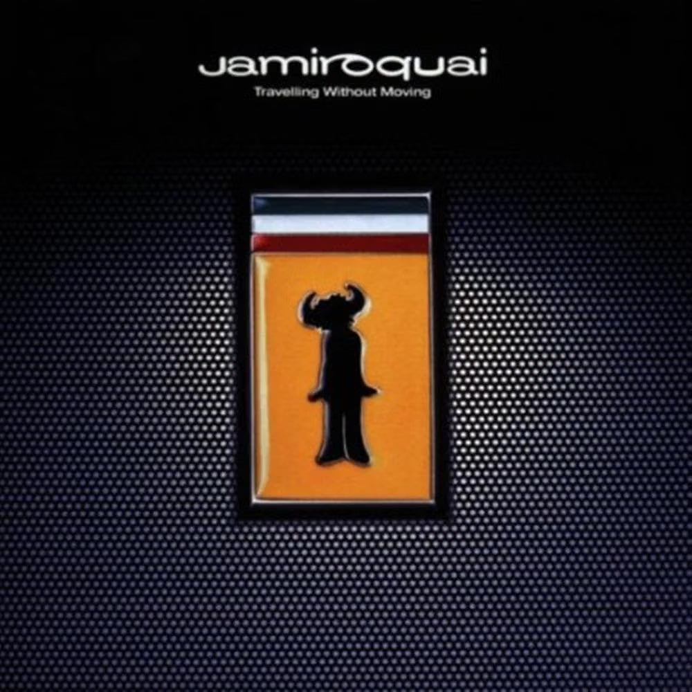 Album cover for Jamiroquai's 'Travelling Without Moving', featuring a central rectangular orange plaque with a black silhouette of a horned figure, set against a dark textured background with the band's name at the top.