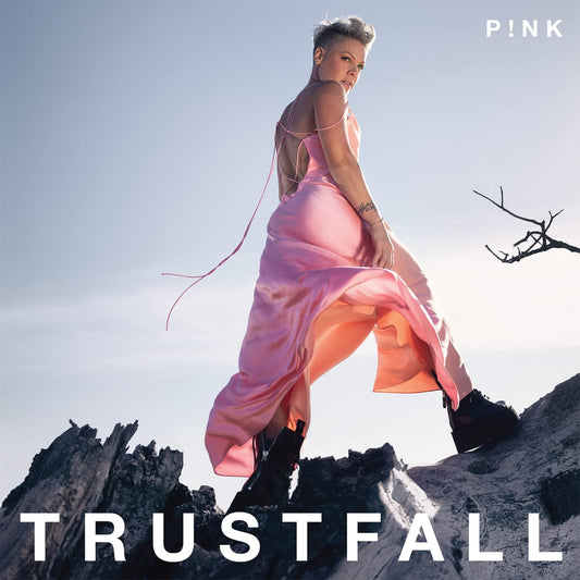 Album cover for 'Trustfall' by P!nk featuring a person in a pink dress on a rocky landscape.