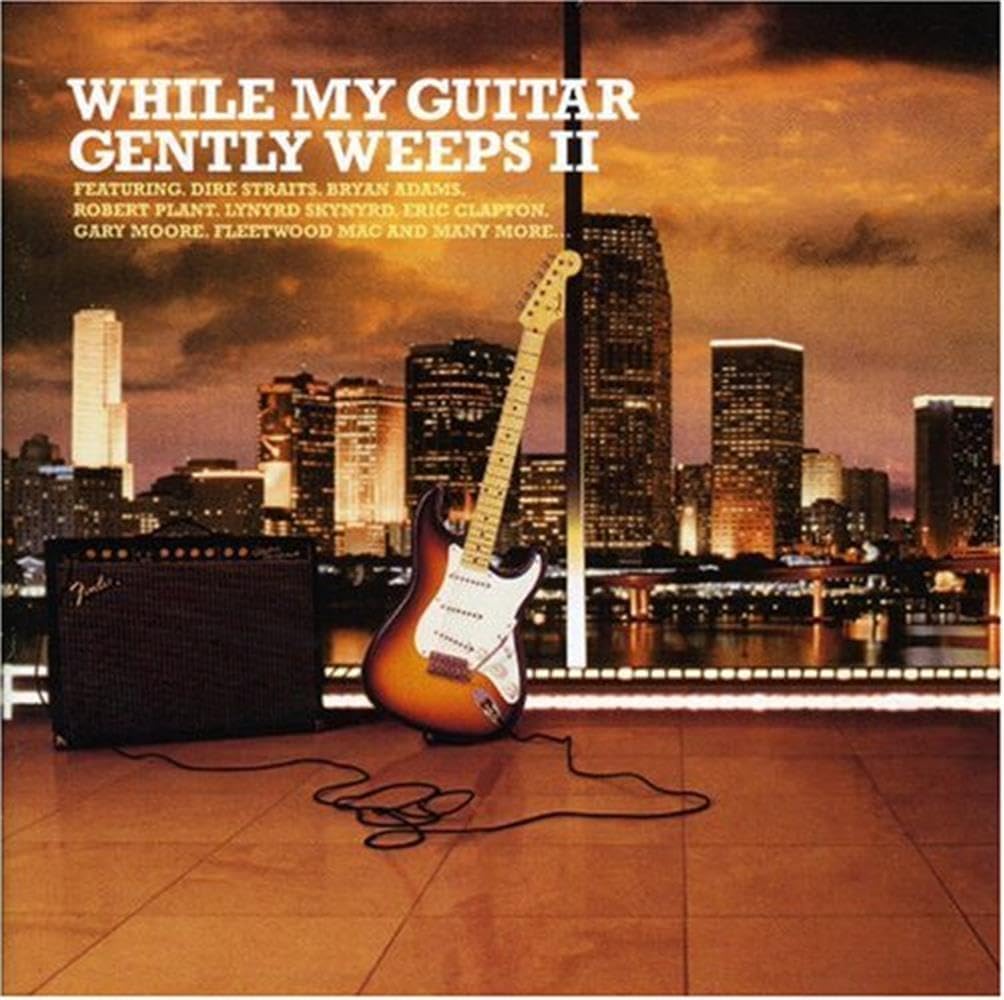 Album cover with guitar and amplifier in front of a city skyline at sunset.