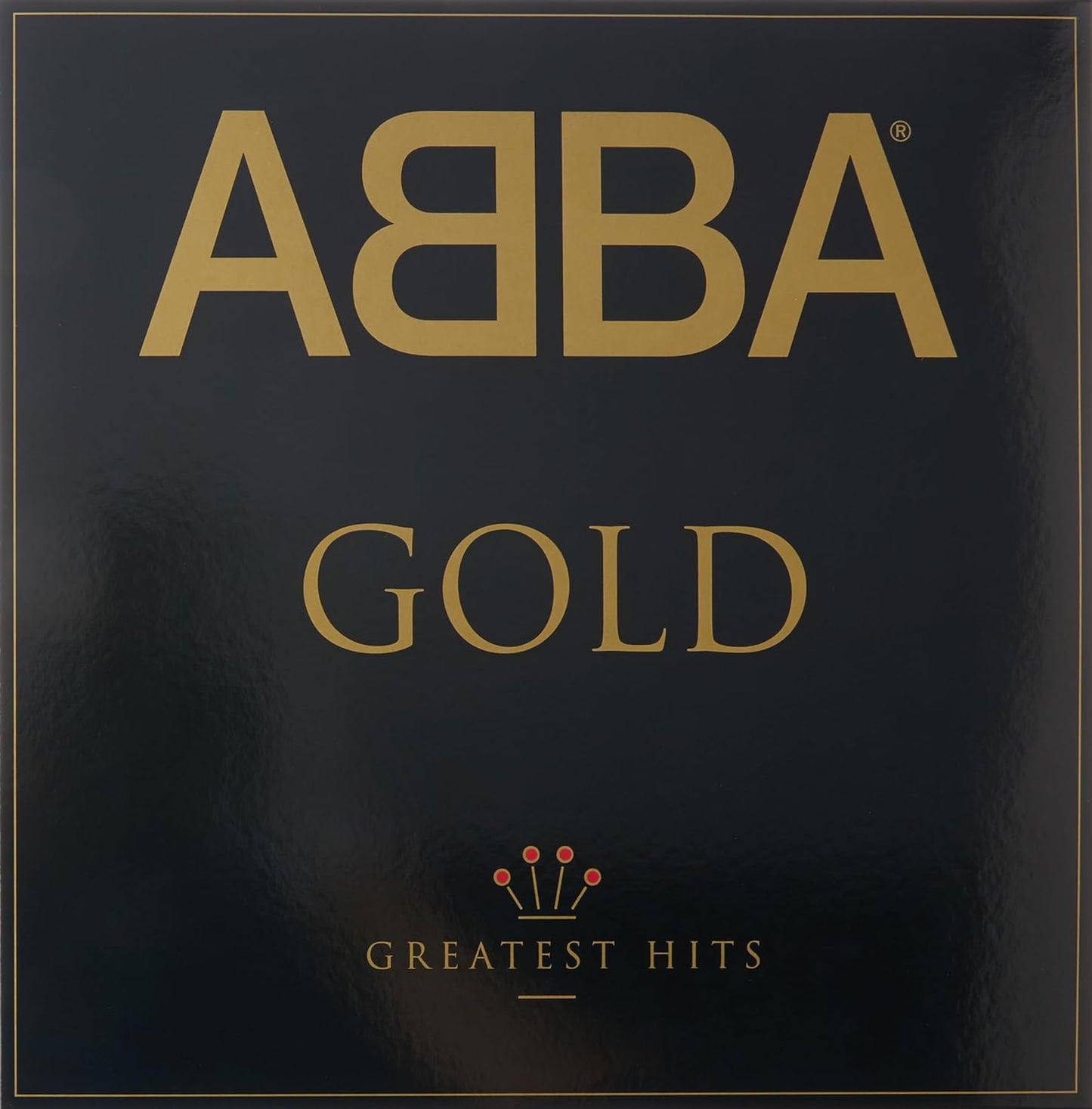 ABBA Gold album cover in vinyl format, featuring the band's logo in gold on a black background with the text 'GREATEST HITS' below it.