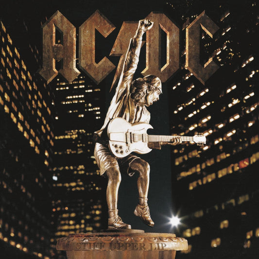 AC/DC band logo with a statue of a guitarist in front of a city skyline at night.
