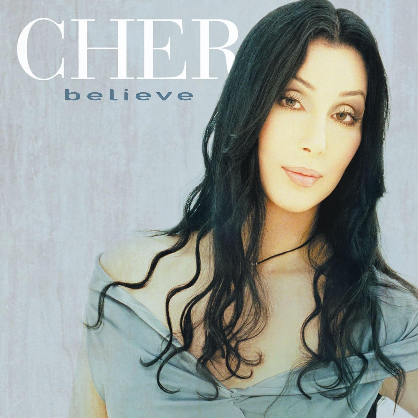 Audio CD cover of Cher's album 'Believe' featuring a portrait of Cher with a gray backdrop.