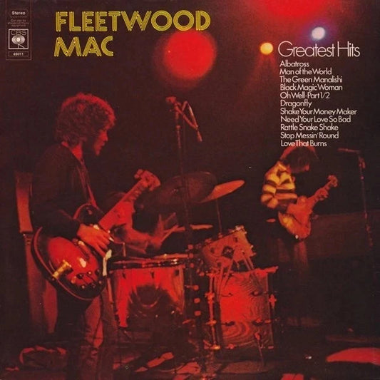 Fleetwood Mac 'Greatest Hits' vinyl album cover, featuring a live performance scene with the band on stage under dramatic red and orange stage lighting. The left side shows Fleetwood Mac playing guitar and drums, while the right side lists the included tracks.