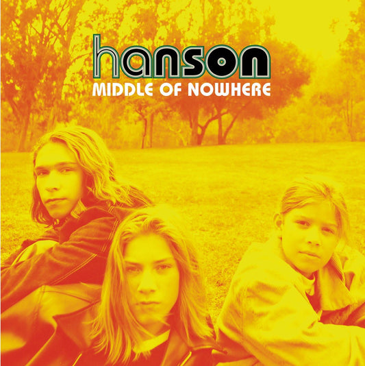 Album cover for 'Middle of Nowhere' by Hanson with three band members sitting in a field.