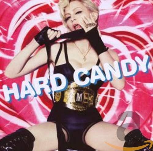 The image features the cover art for Madonna's album "Hard Candy." It shows a close-up of Madonna wearing a black, sleeveless top and black boots, with her mouth partially open and a playful expression.