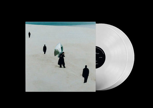 A vinyl record titled 'James Blake - Playing Robots Into Heaven' with a white label and a black cover featuring an artwork of a figure in a desert landscape.