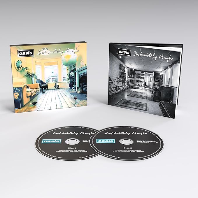 Deluxe edition CDs of Oasis's 'Definitely Maybe' album with a booklet and a digital download code, featuring the band's likeness and a stylized living room scene.