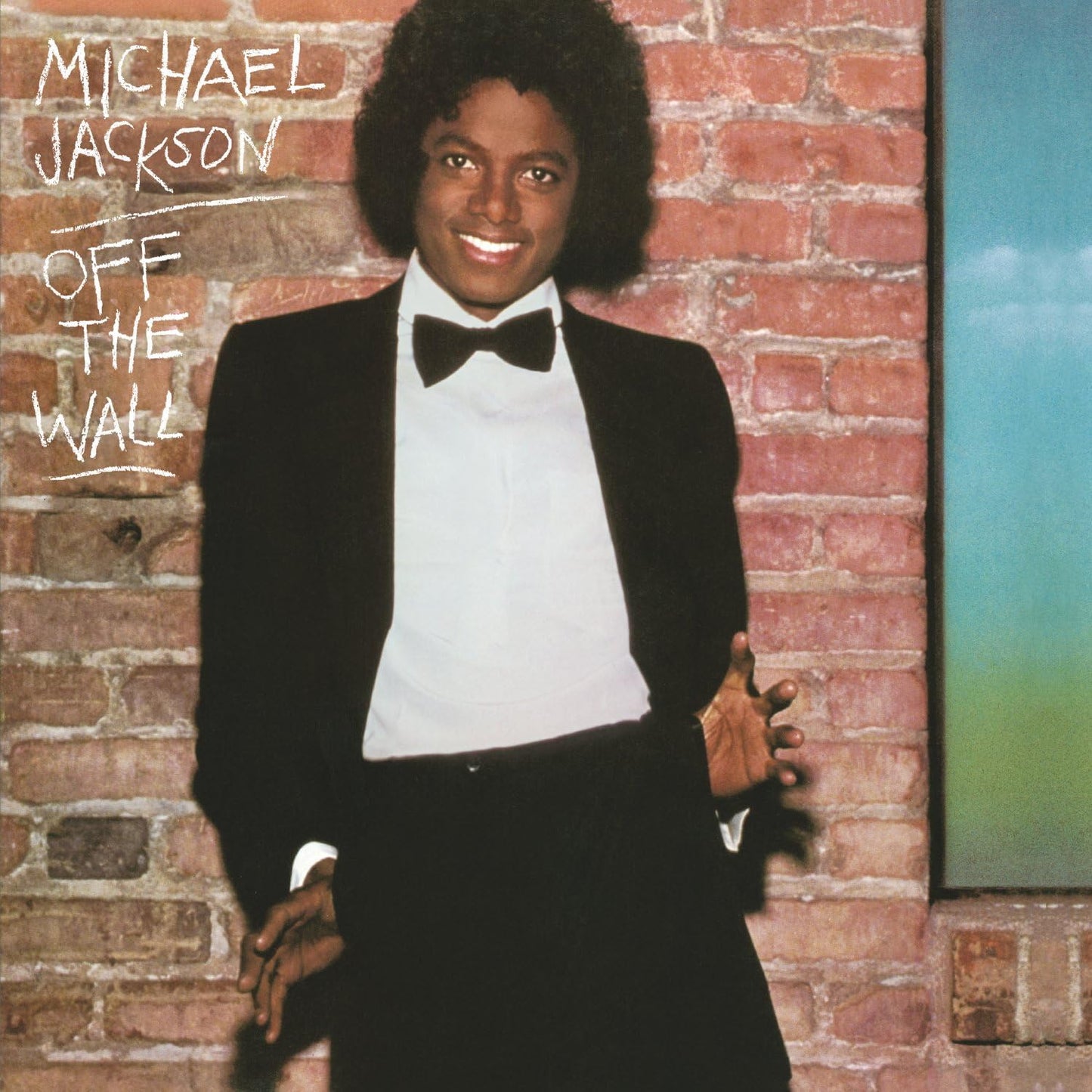 Michael Jackson album cover for 'OFF THE WALL' featuring Michael Jackson in a black tuxedo against a brick wall background.