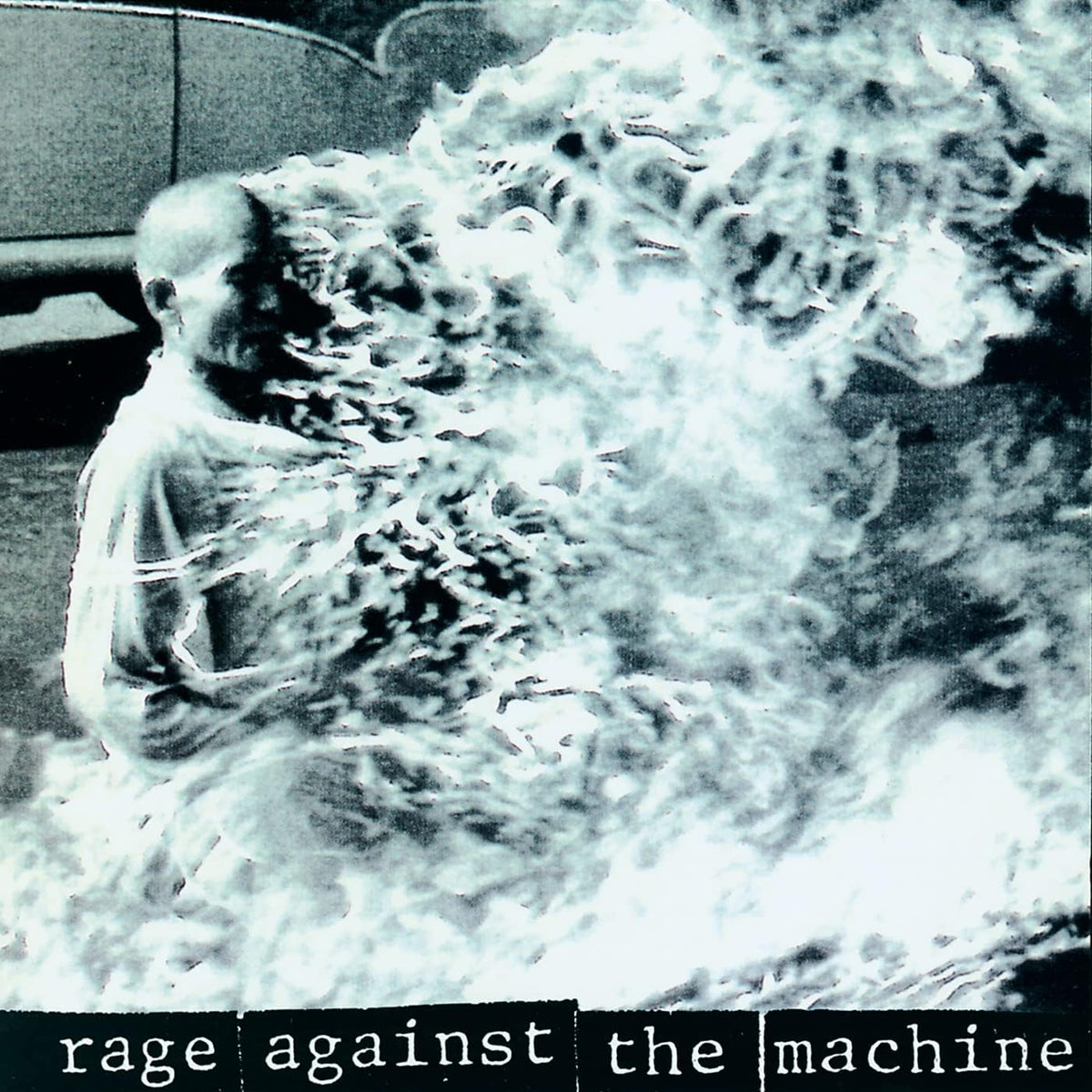 Album cover with a person partially submerged in water, text 'Rage Against the Machine' at the bottom.