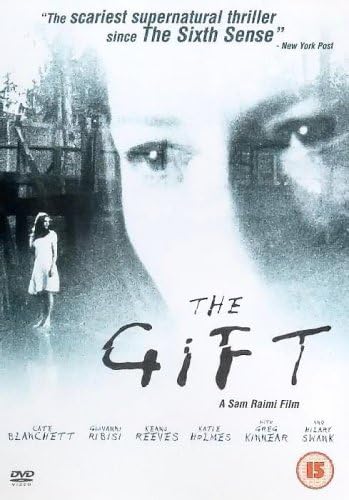 Movie poster for 'The Gift' starring Kate Blatchett, featuring a large grayscale close-up of a woman's face, a small girl in a white dress standing in a dark doorway on the left, and the title 'The Gift' in large stylized text across the center.
