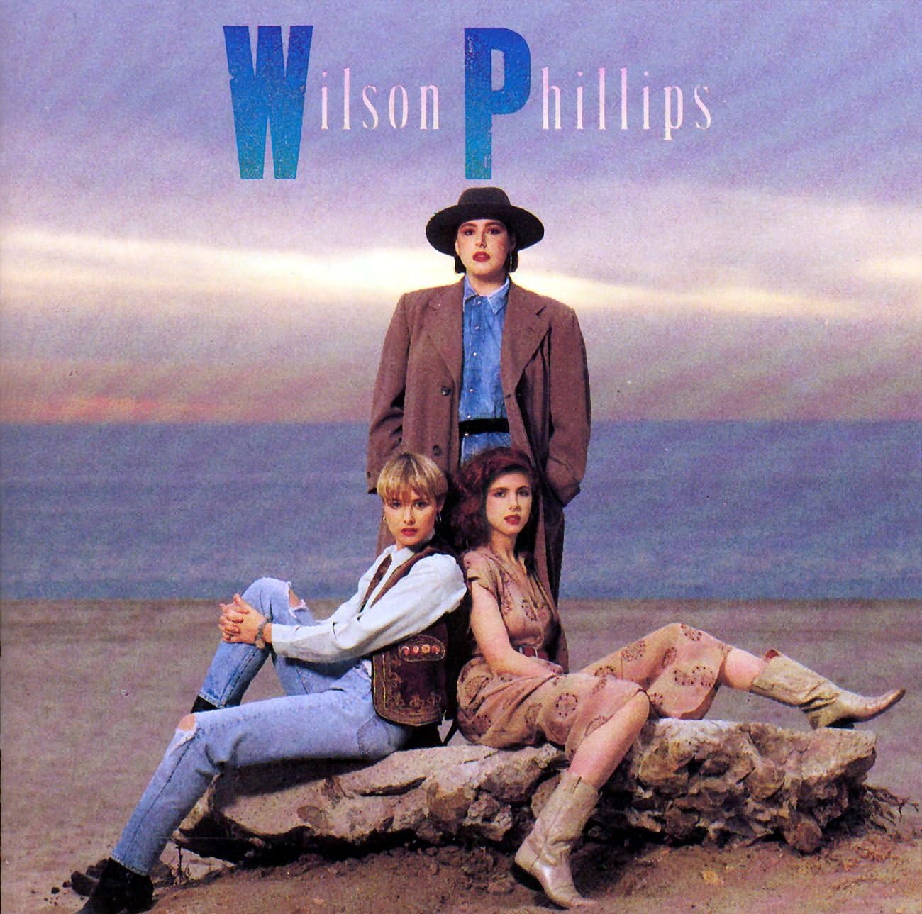 Album cover featuring three people sitting on a rock with 'Wilson Phillips' at the top.