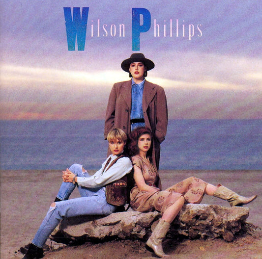 Album cover featuring three people sitting on a rock with 'Wilson Phillips' at the top.