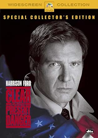 DVD cover of 'Clear and Present Danger' featuring a close-up portrait of an older man with a serious expression, against a background suggesting a military or political setting with a red and blue banner.
