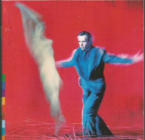 A CD cover featuring a man on a red background, performing a dance with a misty, ethereal background. The man is wearing a blue shirt and the image has a blurred, artistic quality to it.